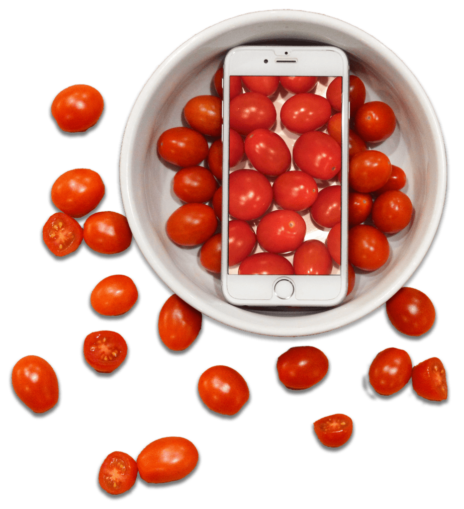 Phone sits in a bowl of tomatoes